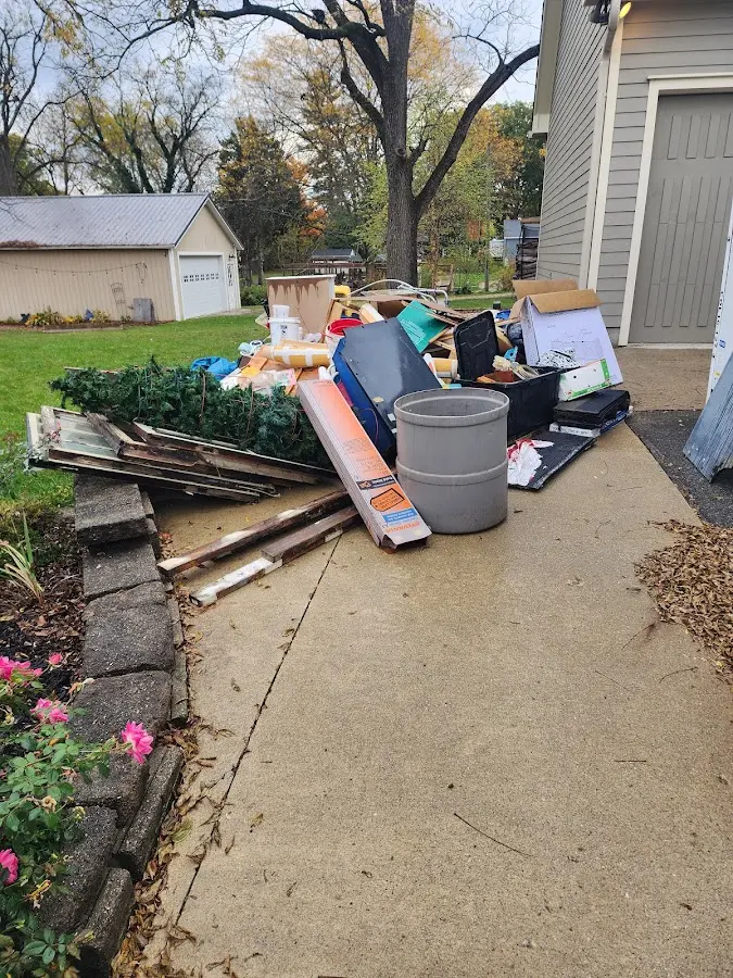 Dumpster being loaded with debris for 12 Yard Dumpster Rental in Pelham Manor
